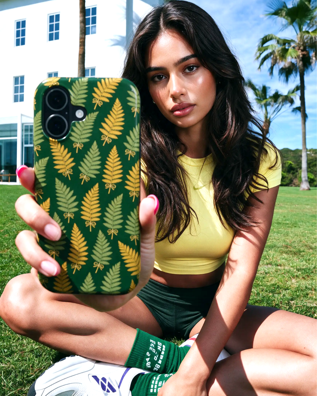 Model holding WIld Fern phone case